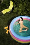 Dark haired stunner Eugenia Diordiychuk shows her bum and big tits in the pool