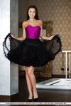 Brunette teen Alisa Amore doffs a corset and tutu skirt to model totally naked