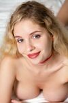 Adorable teen Mila Amour removes her red dress & reveals her amazing big tits