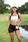 Skinny amateur Tita Sahara poses in a short golfer skirt on the golf course
