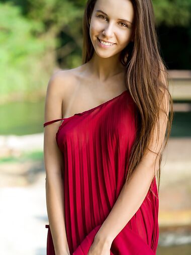 Beautiful teen Alisa Amore disrobes for nude solo poses near a dam