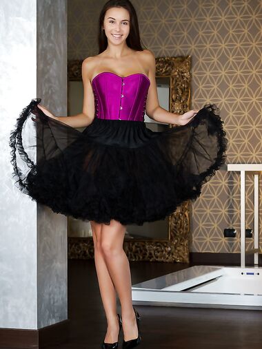 Brunette teen Alisa Amore doffs a corset and tutu skirt to model totally naked